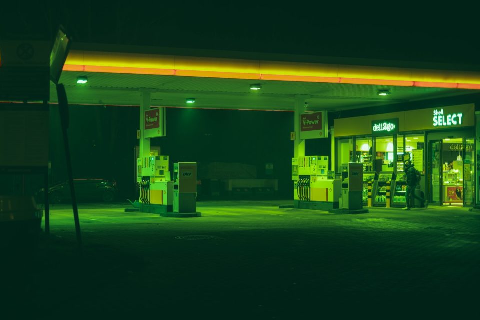 a gas station at night with neon lights