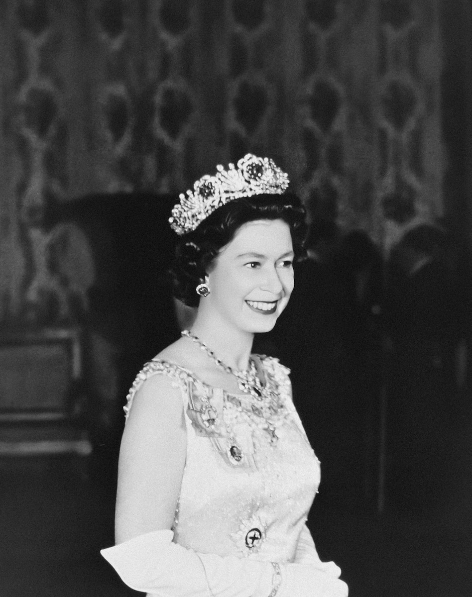 a black and white photo of a woman wearing a tiara