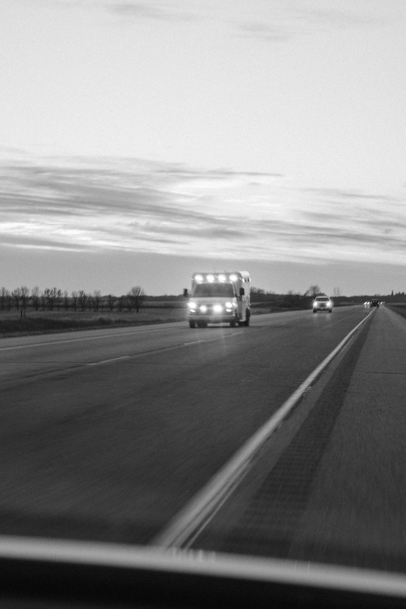 grayscale photo of car on road