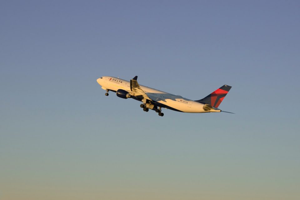 An airplane flying in the sky with a sky background
