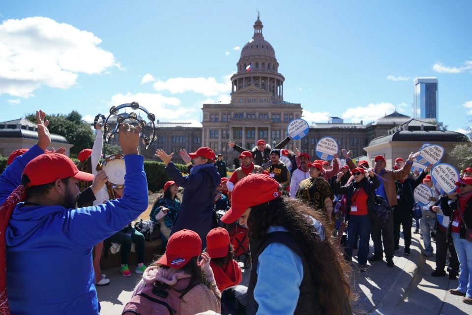 A large group of people standing in front of a building