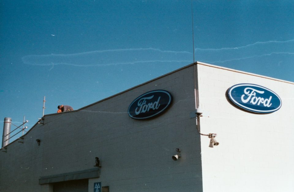 a ford dealership with a blue sky in the background