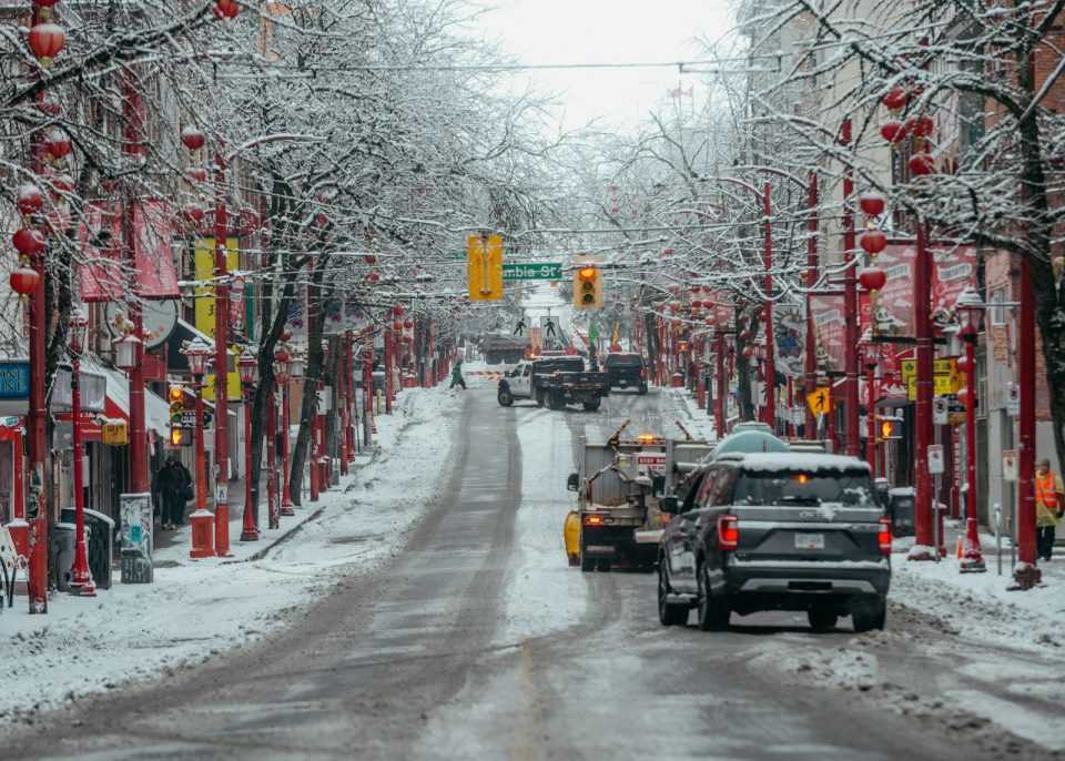 A car driving down a snow covered street