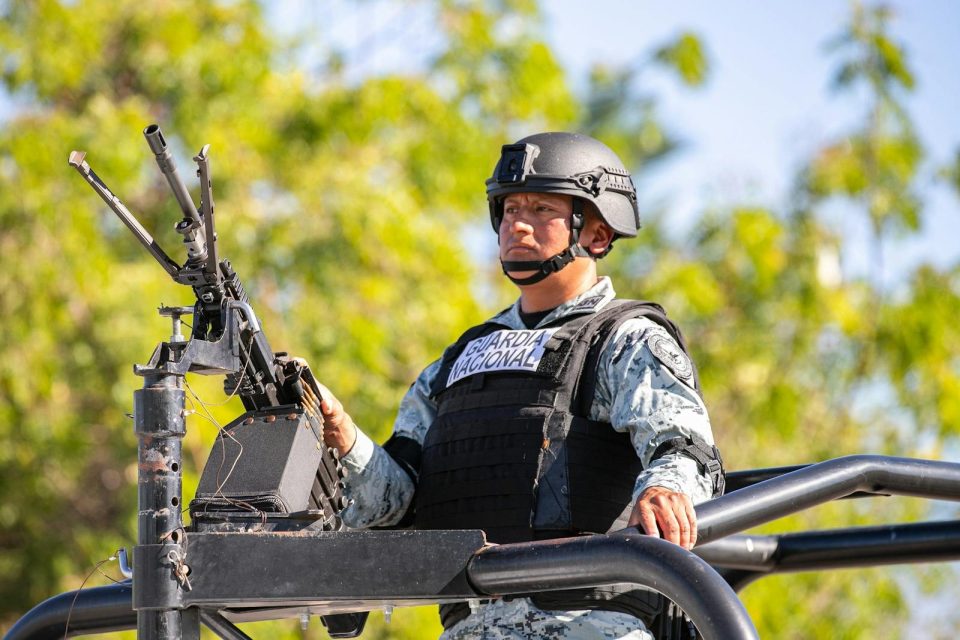 National Guard officer in uniform and helmet, outdoors in CDMX, Mexico, during the day.