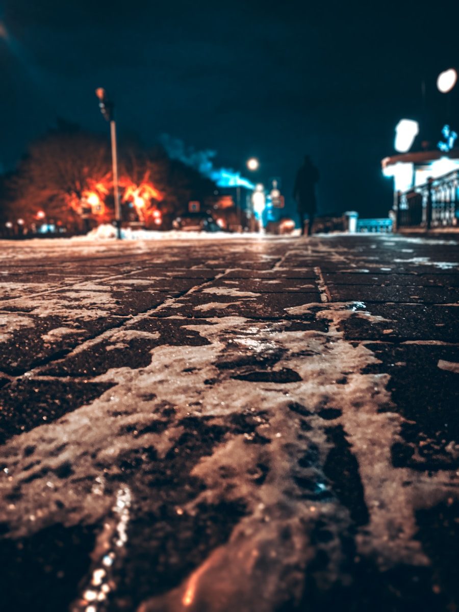 brown concrete road with water droplets during night time