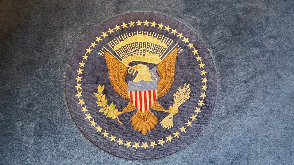 The great seal of the united states on a rug.