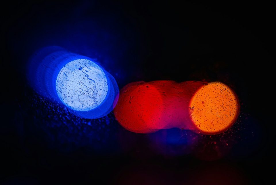 A close up of a traffic light with blurry lights
