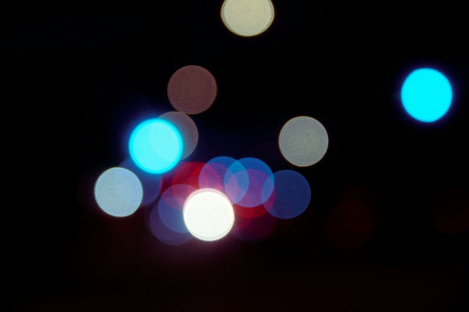 A blurry photo of a street light at night