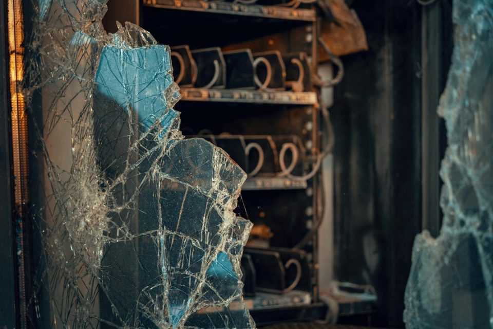Close-up of shattered glass with industrial shelving in an Austrian setting.