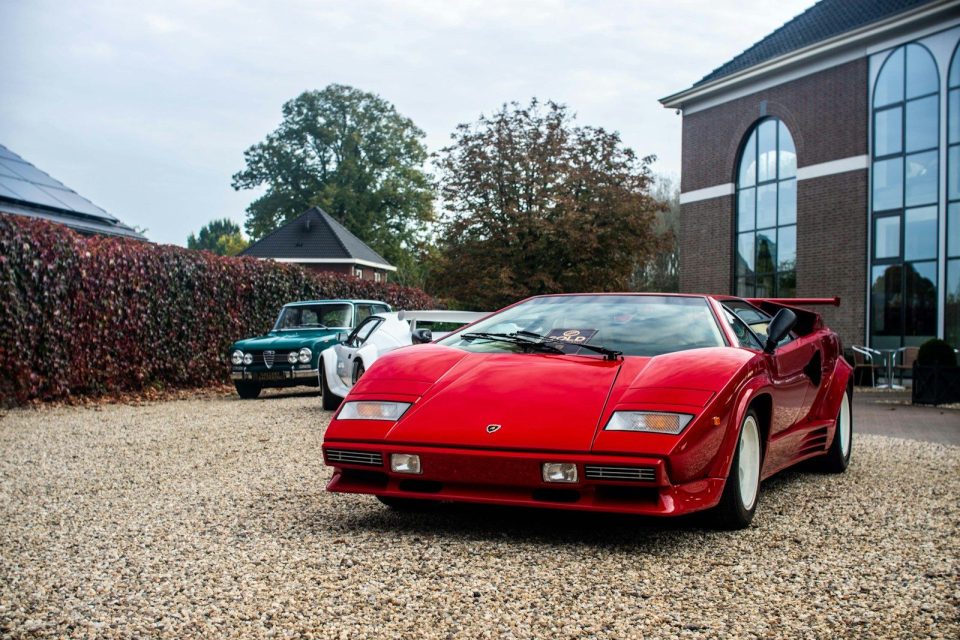 A red sports car parked in front of a building