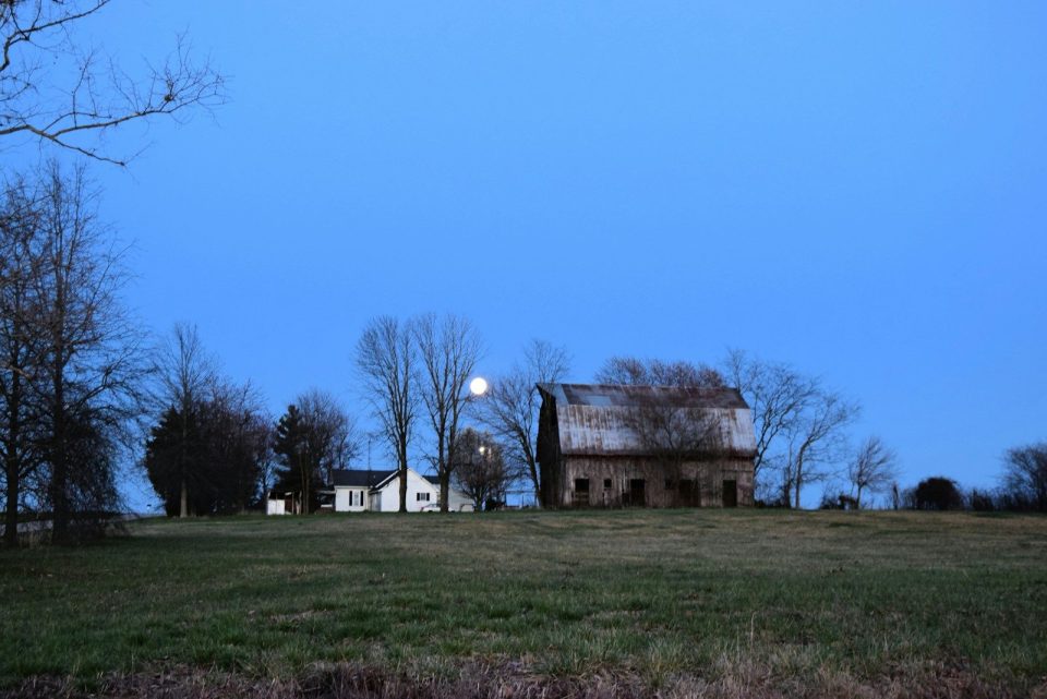 A large house sitting on top of a lush green field