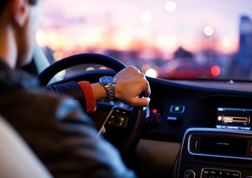Photo by why kei man driving a car wearing wrist watch