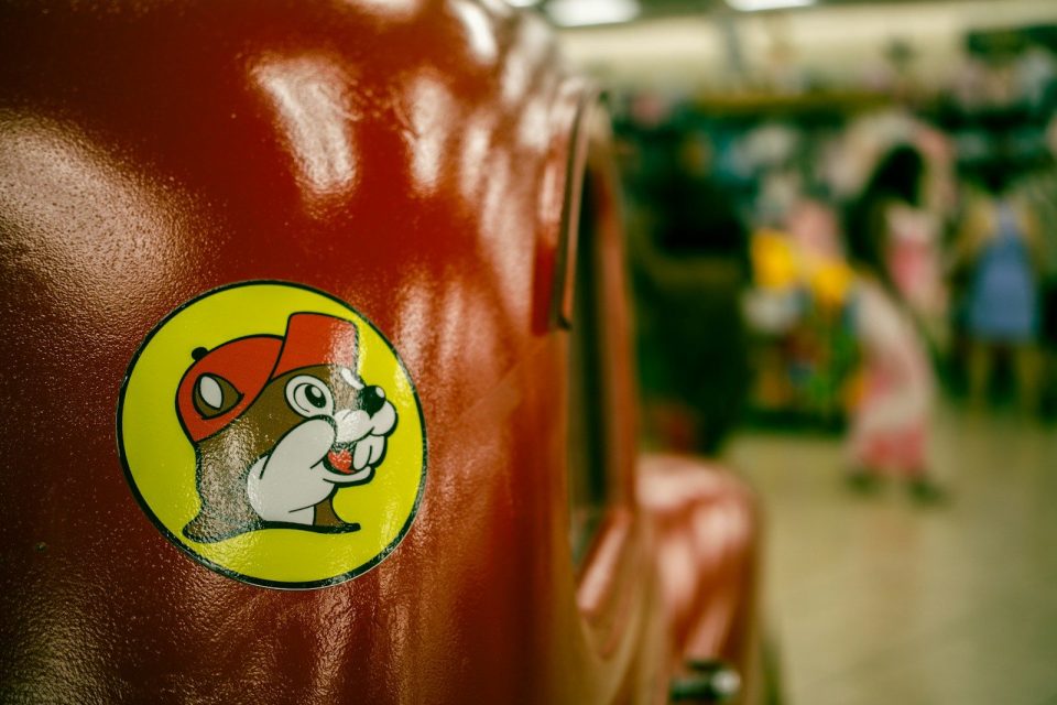 Buc-ee's beaver logo on a red surface.
