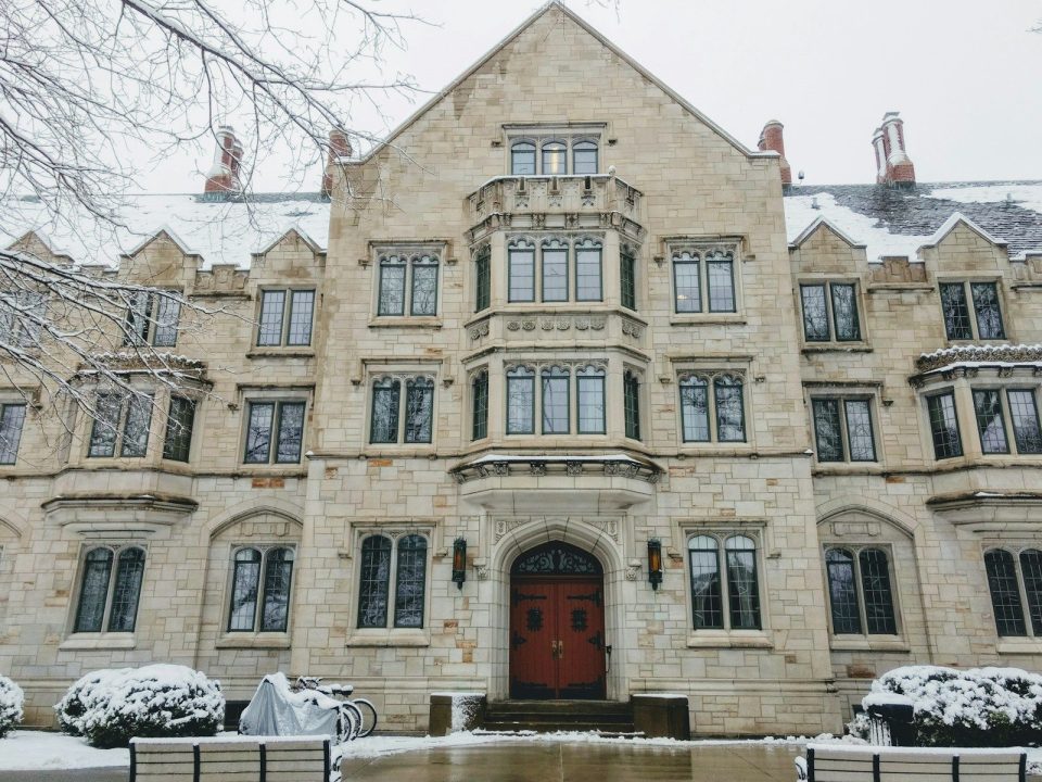 a large stone building with a red door