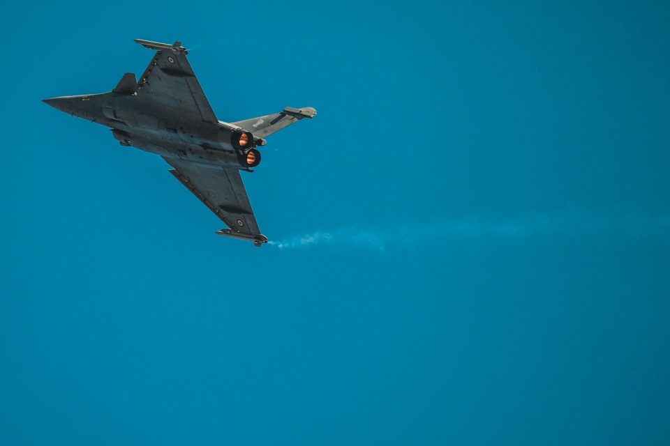 gray and brown plane flying on sky