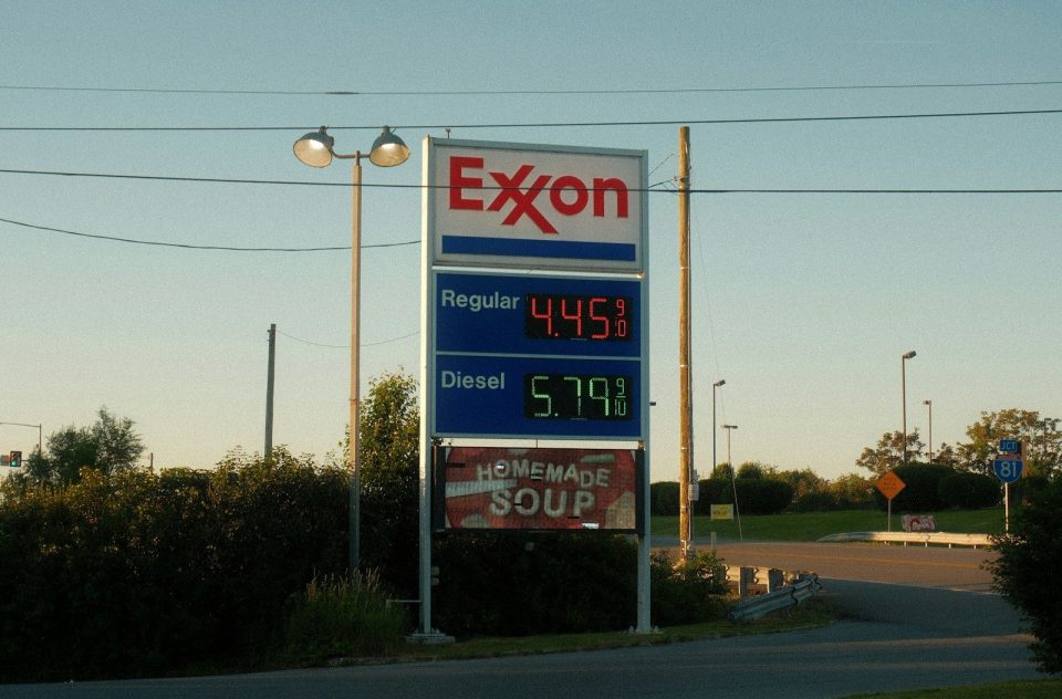 Exxon gas station sign displaying fuel prices and soup advertisement