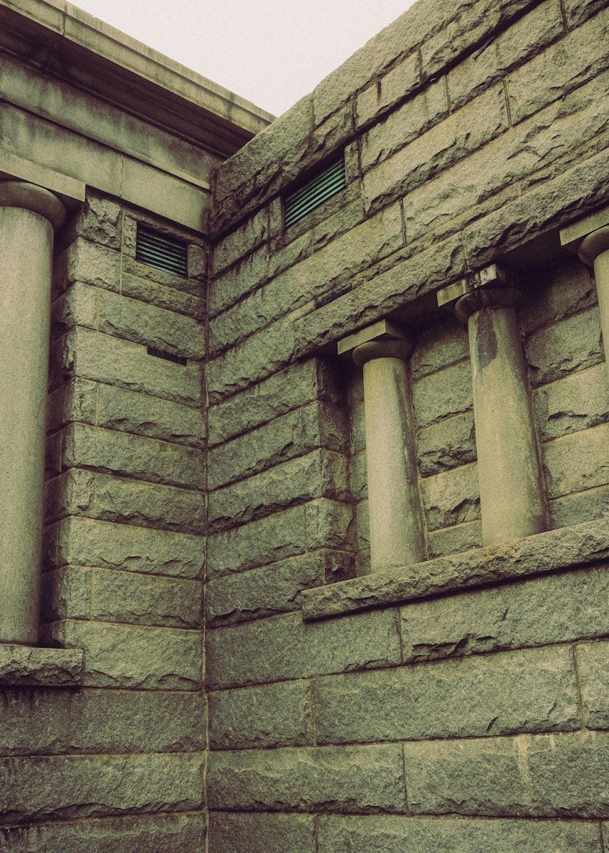 Stone building corner with columns and vents