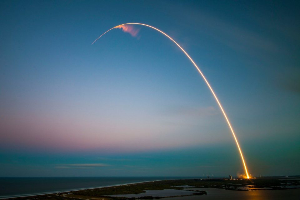rocket launch light trail at dusk