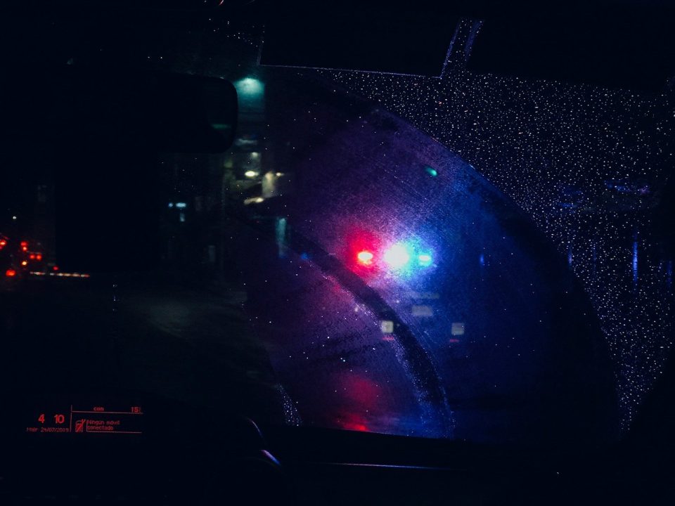 a close up of a car's rear view mirror at night