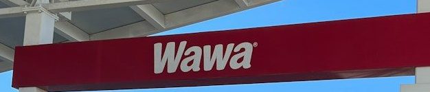 a red and white sign that reads wawa